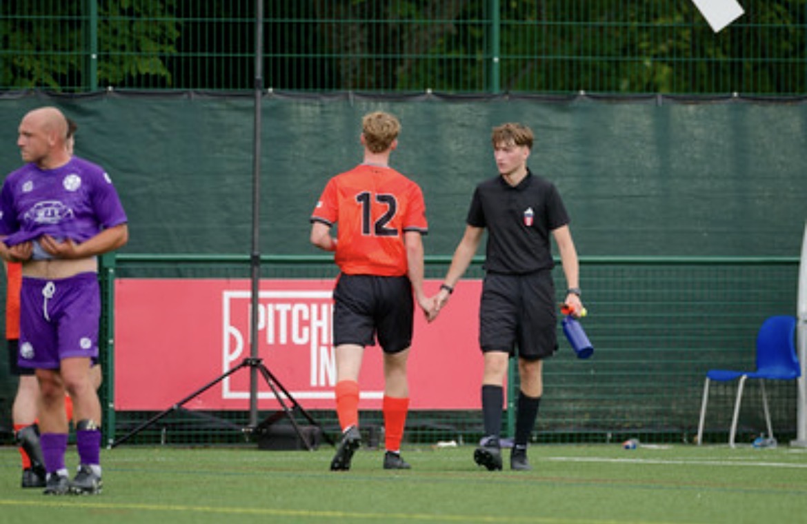 Whiteley number 12 walking off the pitch alongside the referee