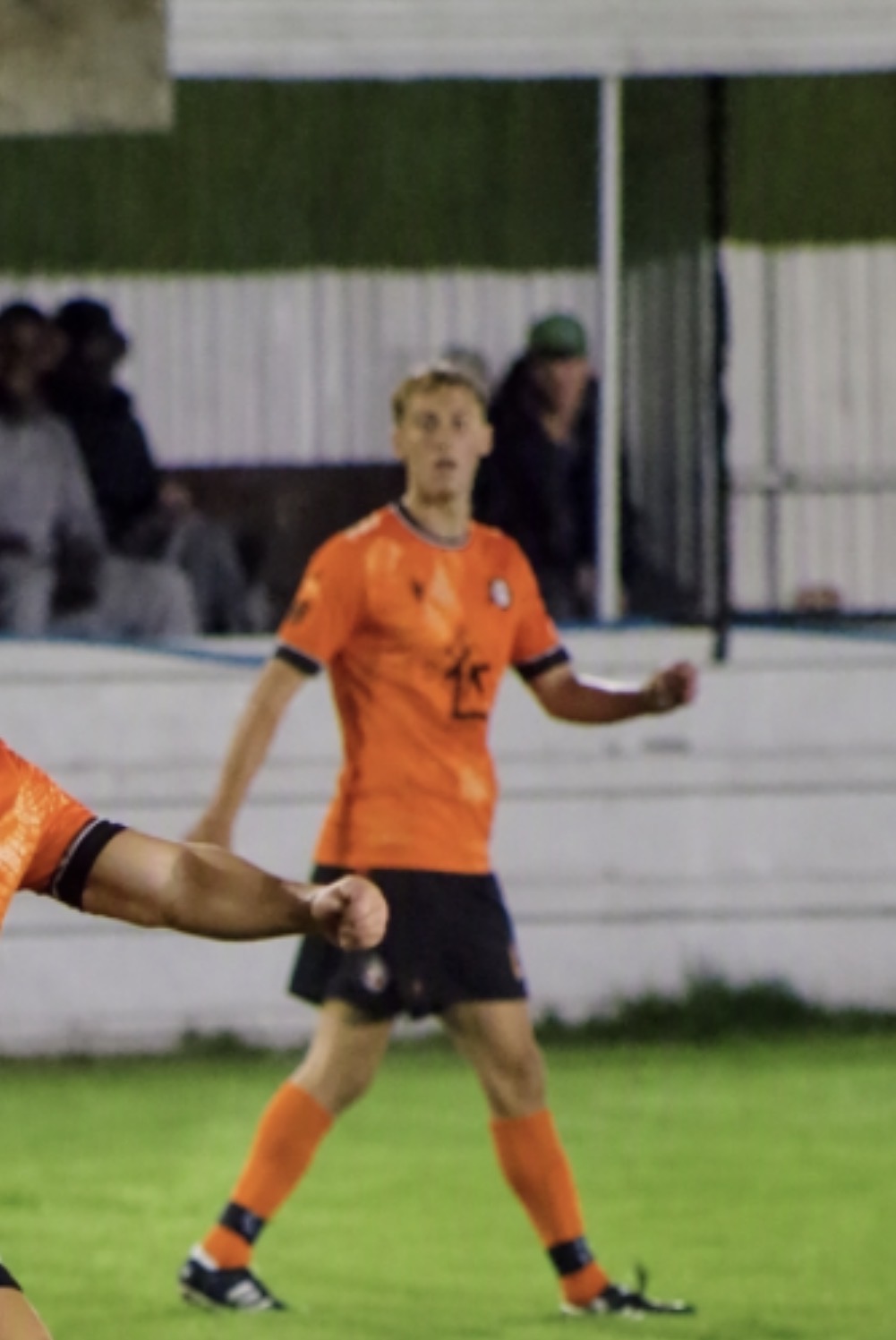 A Whiteley player in orange kit during an evening match