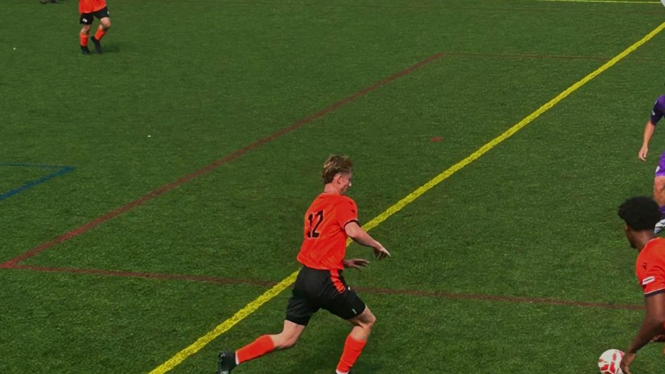 Whiteley player making a sliding defensive challenge against Twentyten